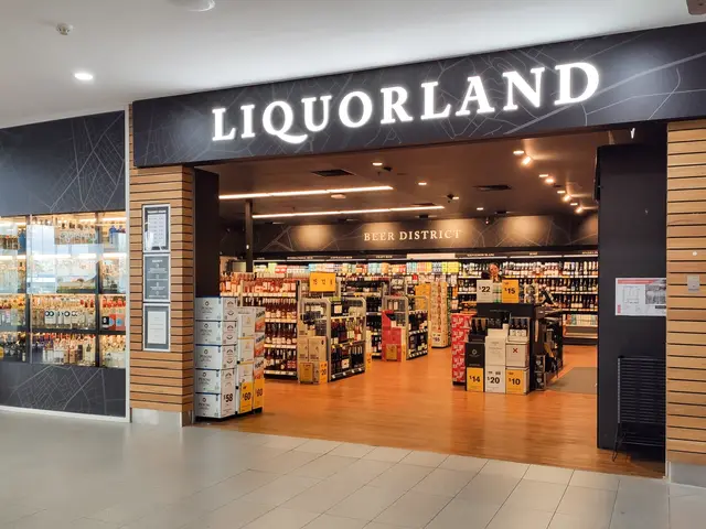 The image shows a liquorland store in a shopping mall with a sign that reads "Liquorland" on the...