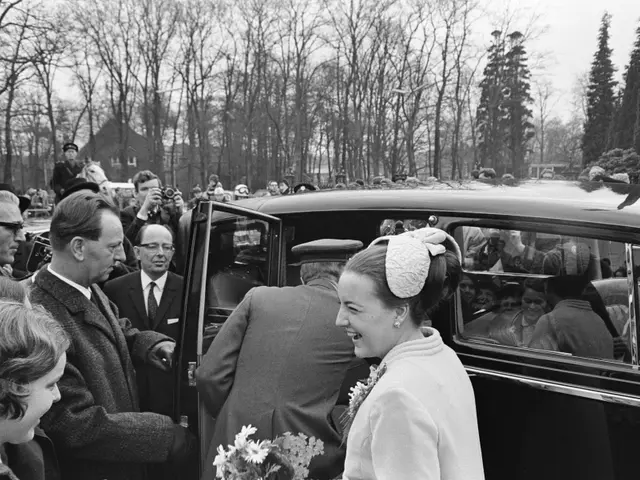 The image shows a black and white scene of Queen Elizabeth II and Prince Philip, Duke of Edinburgh,...