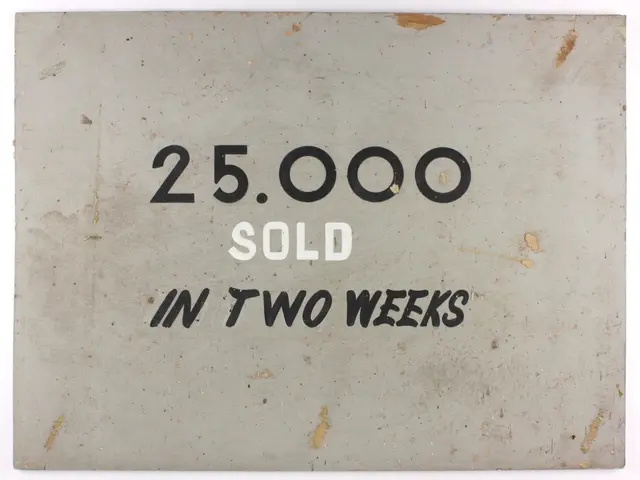 The image shows a white background with a sign that reads "25,000 sold in two weeks" in bold black...