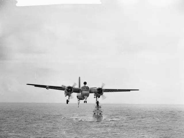 The image shows a black and white photo of an airplane taking off from an aircraft carrier in the...