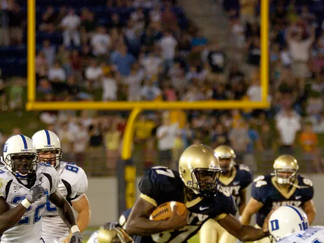 The image shows a football player running with the ball during a game, surrounded by a group of...