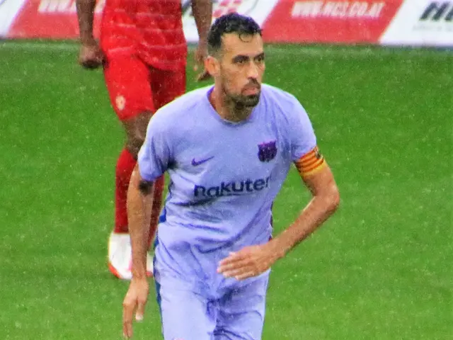 The image shows a soccer player in action on the field, wearing a sports uniform and footwear. In...