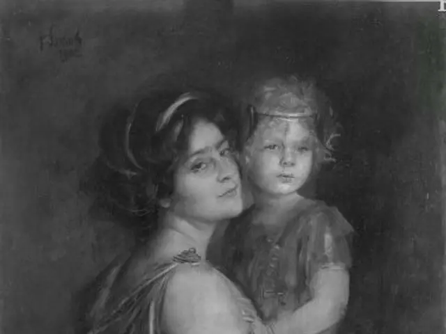 The image shows a black and white portrait of a woman holding a child. The woman has a gentle...