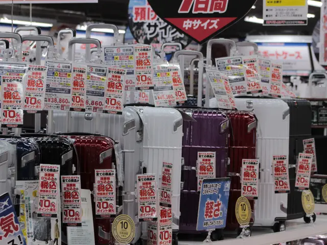 The image shows a store filled with lots of different types of suitcases, each with a price tag...