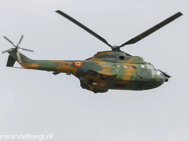 The image shows a military helicopter flying through the air with its landing gear down, its rotor...