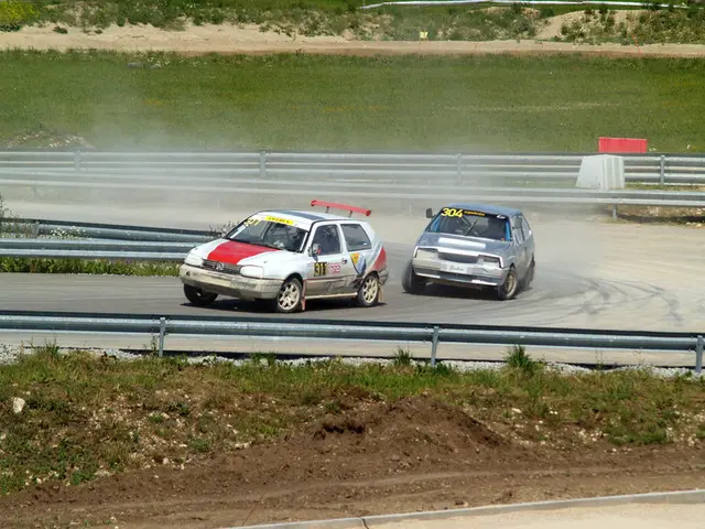The image shows two cars racing on a race track with smoke coming out of them, surrounded by grass,...