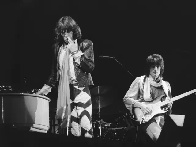 The image shows Mick Jagger and Keith Richards of the Rolling Stones performing on stage at the...