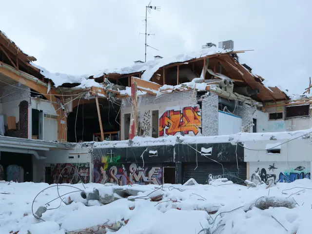 The image shows a building that has been torn down in the middle of a snowy field. The ground is...