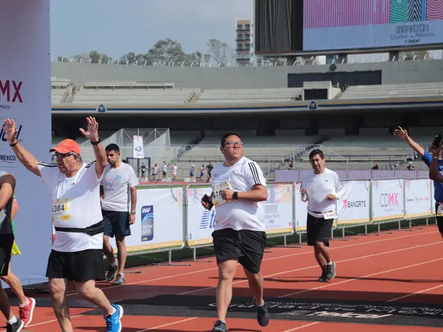 The image shows a group of men running on top of a track, with a banner on the left side of the...