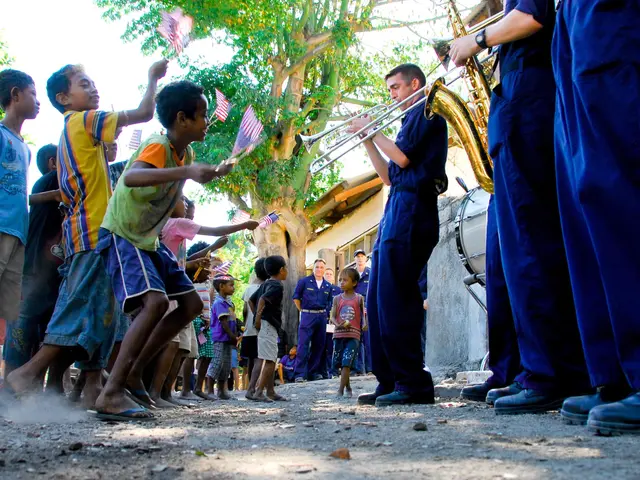 The image shows a group of children playing musical instruments in front of a crowd of people, some...