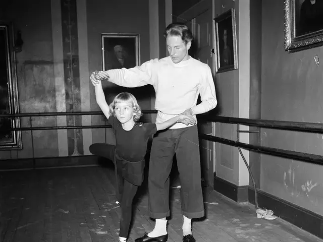 The image shows a man and a little girl dancing in a dance studio. The man is wearing a white shirt...