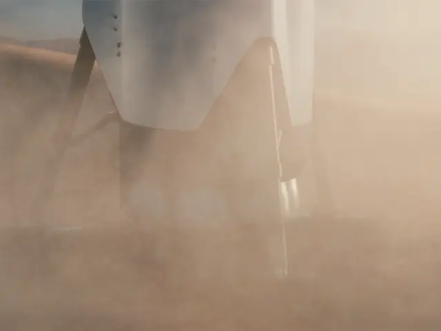The image shows a close up of a vehicle driving through a dust storm, with the sky in the...