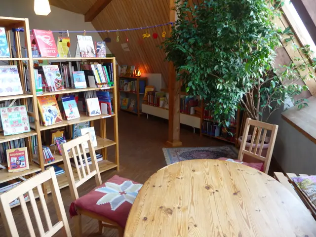 The image shows a cozy reading room with a wooden table and chairs surrounded by bookshelves filled...