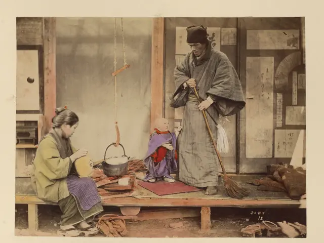 The image shows a Japanese couple and their child sitting on a bench in front of a wall. The woman...