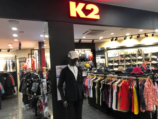 The image shows a K2 clothing store in Singapore, with mannequins wearing caps, clothes hung on...