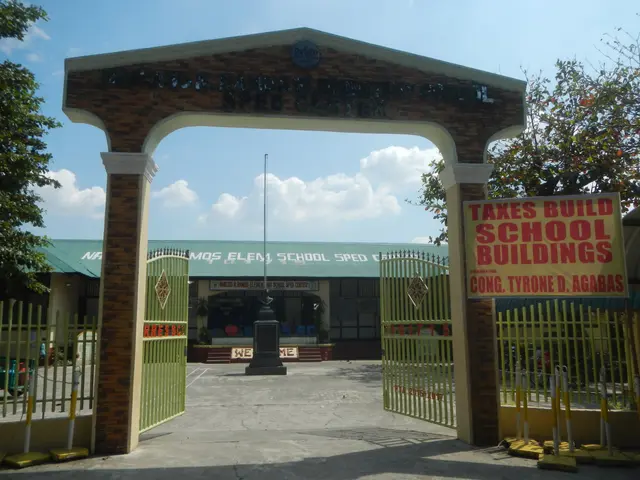 The image shows the entrance to a school building with a sign that reads "Takes Build School...
