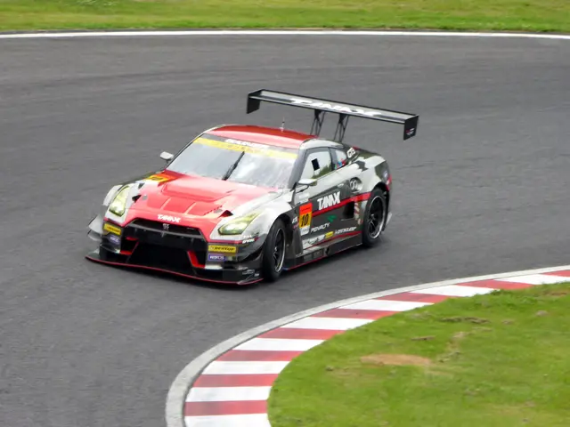 The image shows a Nissan GT-R Nismo GT3 on the Nürburgring 24 Hours race track, surrounded by lush...