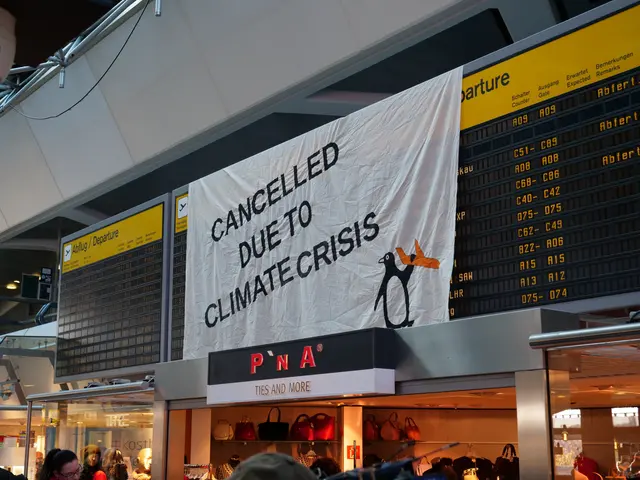 The image shows a group of people standing in front of an airport departure board with a banner...
