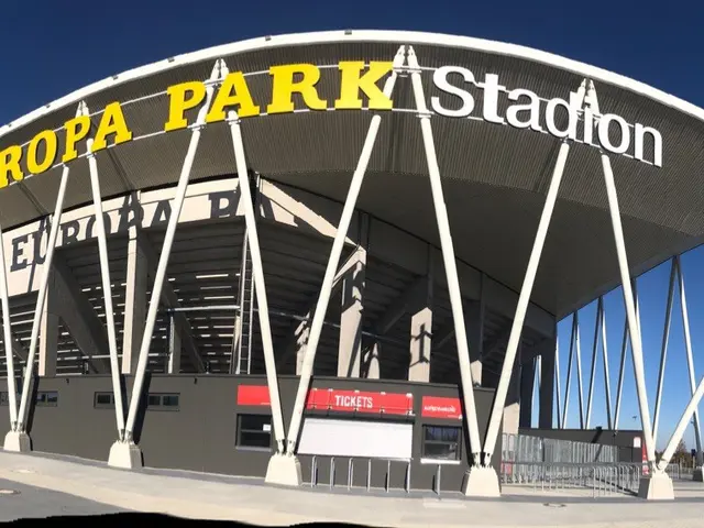 The image shows the Europa Park Stadium in Barcelona, Spain. It is a large building with text on...