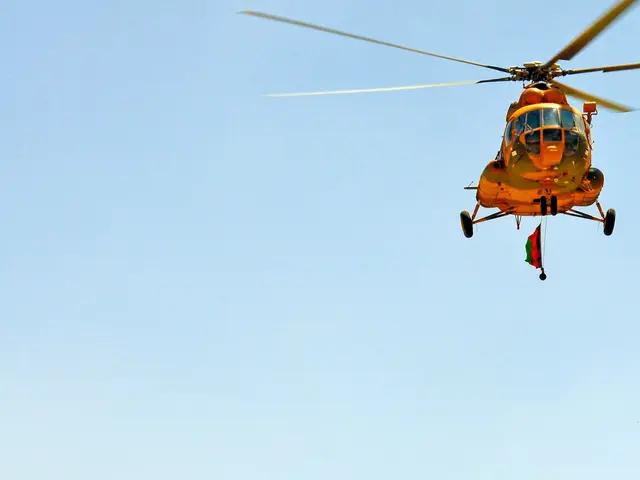 The image shows a group of helicopters flying over a desert landscape with hills in the background...