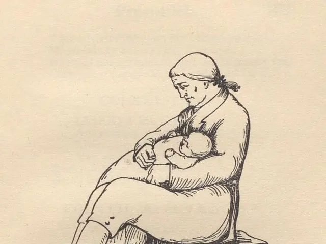 The image shows a woman sitting on a chair, cradling a baby in her arms. She has a peaceful...