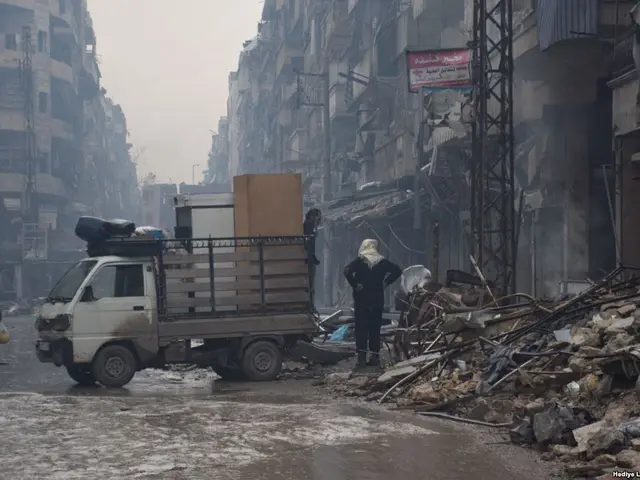 The image shows a truck driving down a street next to a pile of rubble, with people walking on the...