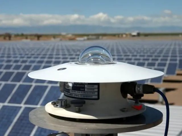 The image shows a solar panel with a light on top of it, surrounded by solar panels on the ground...