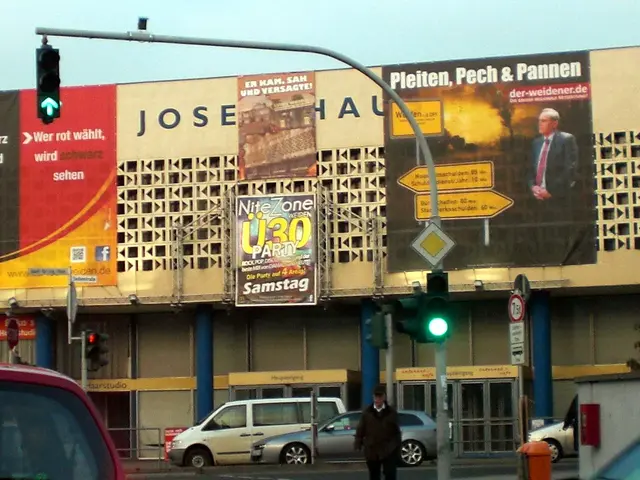 The image shows a red car driving down a street next to a traffic light, with a person walking on...