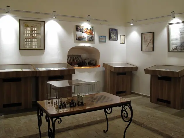 The image shows a room filled with lots of tables and chairs, each with a chess board and pieces on...