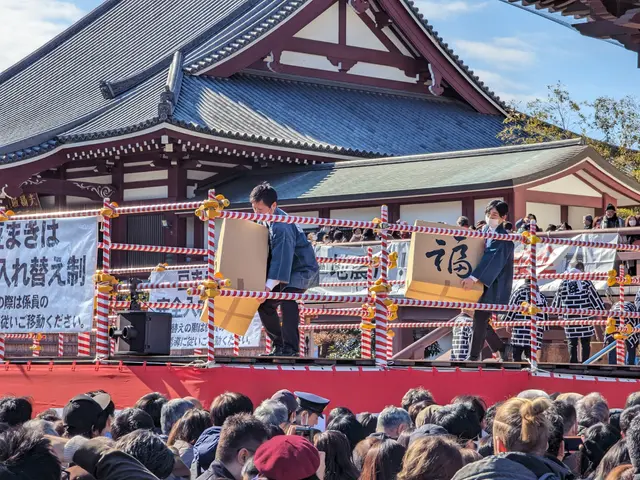 The image shows a group of people standing on top of a stage in front of a building, with two...