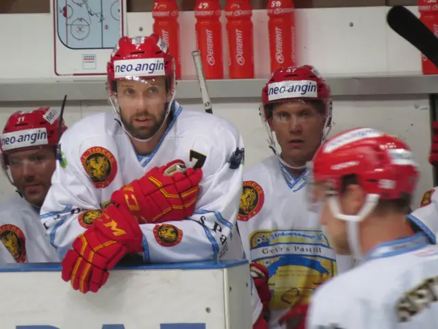 The image shows a group of men standing next to each other on top of a hockey rink. They are all...