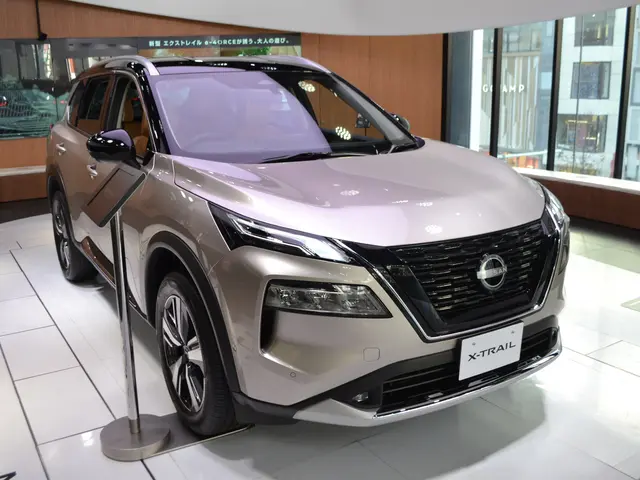 The image shows a Nissan X-Trail electric SUV on display at the Tokyo Motor Show. It is a sleek,...