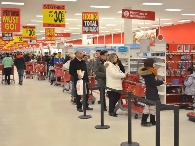 The image shows a large group of people in a store with shopping carts, standing on the floor and...