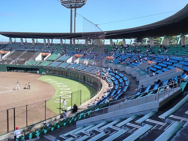 The image shows a baseball game being played in a stadium, with people sitting in the stands and...