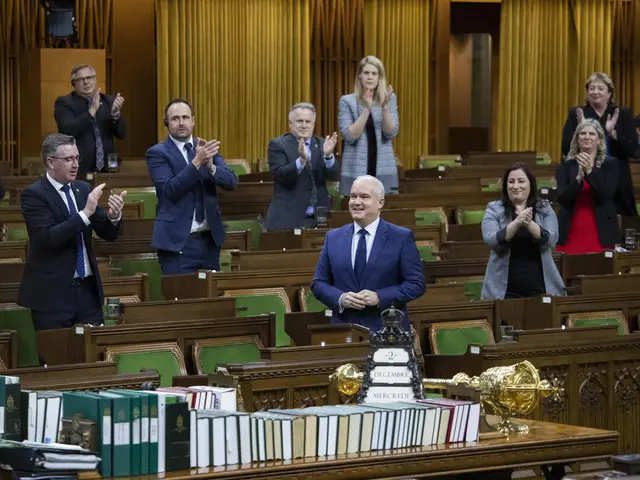 The image shows a group of people standing in the middle of a room, clapping their hands in...