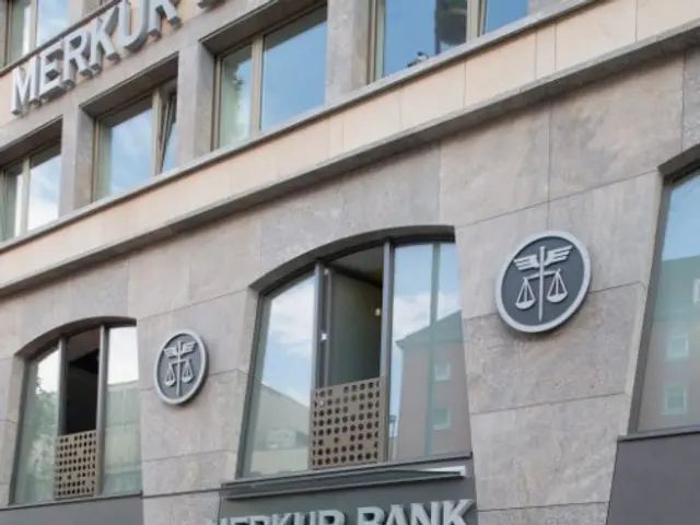 The image shows a building with glass walls and doors, with the words "Merkur Bank" written on the...
