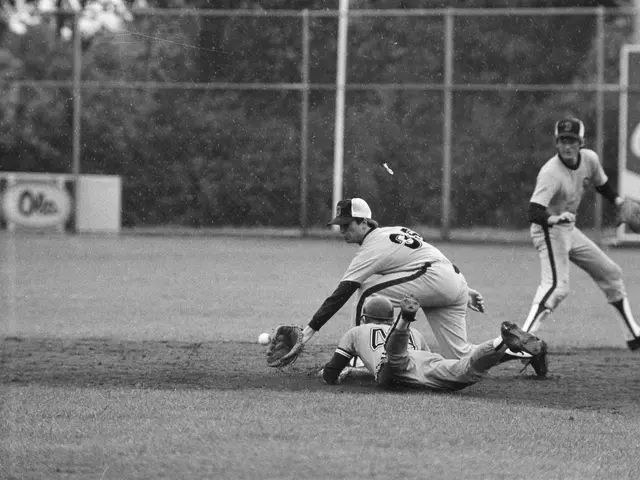 The image shows a baseball player sliding into home plate during a game. The player is wearing a...