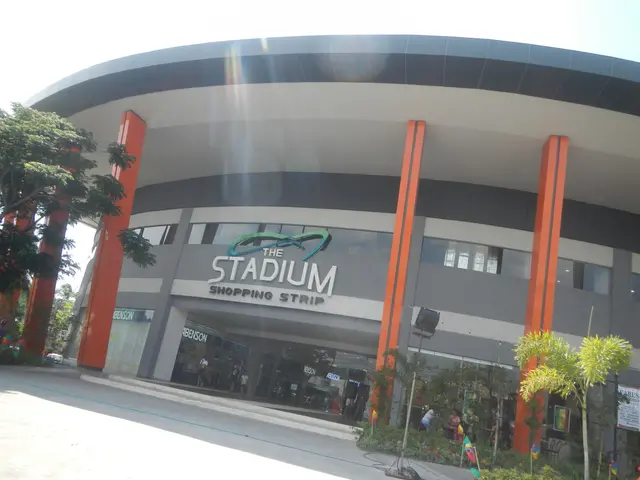 The image shows the Stadium Shopping Strip in Manila, Philippines. It is a large building with...