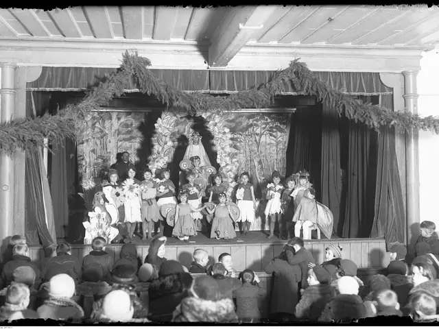 The image shows a group of children standing on top of a stage in front of a crowd of people...
