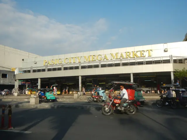 The image shows a bustling Pasig City Mega Market, with vehicles on the road and people walking...