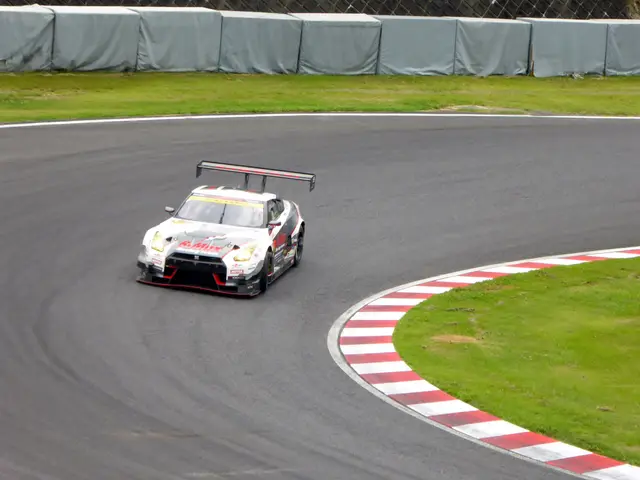 The image shows a Nissan GT-R Nismo GT3 on the Nürburgring 24 Hours race track, surrounded by lush...