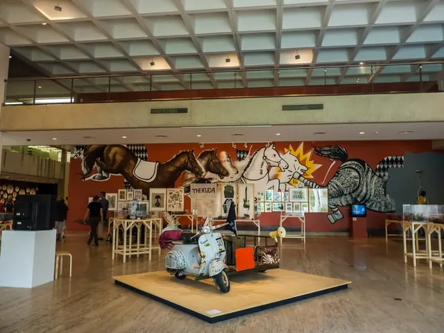 The image shows a large room filled with lots of tables and chairs, a motor scooter on the floor, a...