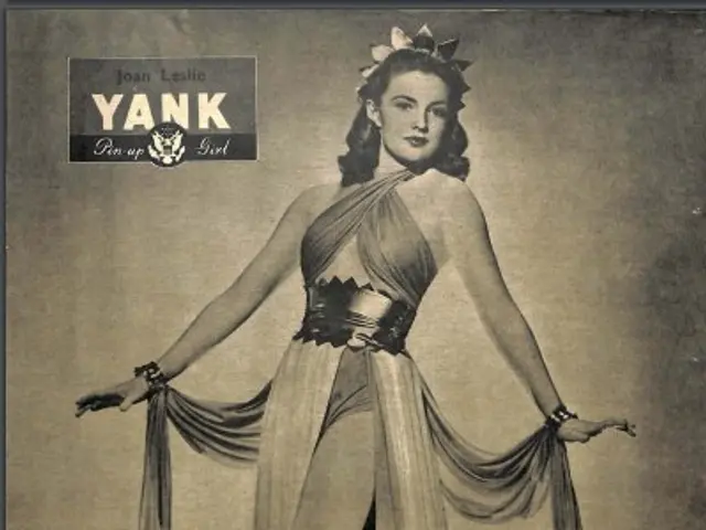 The image shows a woman in a dress standing on a stage, framed in a photo frame. At the top of the...