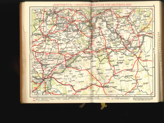 The image shows an open book with a map of Germany on it, set against a black background. The map...