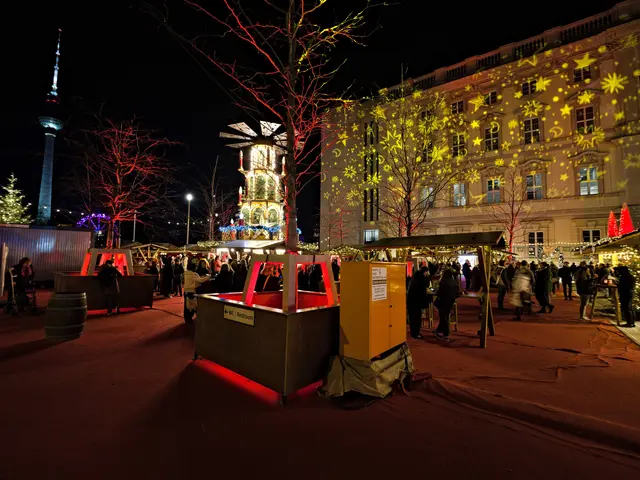 The image shows a bustling Christmas market in Berlin, Germany. There are many people gathered...