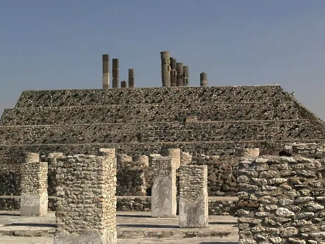 The image shows the ruins of the ancient city of Teotihuacan, Mexico, with a pyramid in the center...
