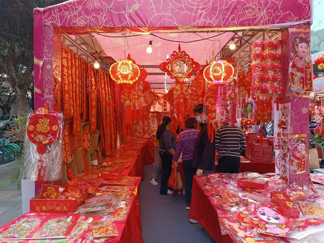 The image shows a bustling Chinese New Year market in Hong Kong, with people standing on the floor...