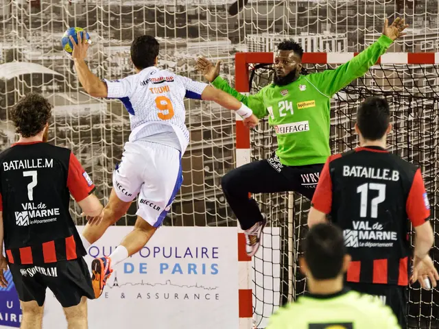 The image shows a group of men playing a game of handball, with one of them jumping and holding a...