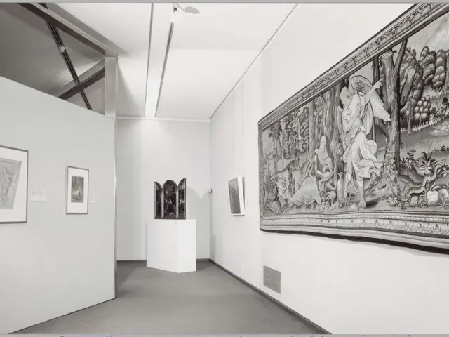 The image shows a black and white photo of a room with a large tapestry hanging on the wall, photo...