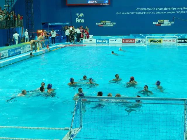 The image shows a group of people playing water polo in a pool, with a net in the foreground and a...